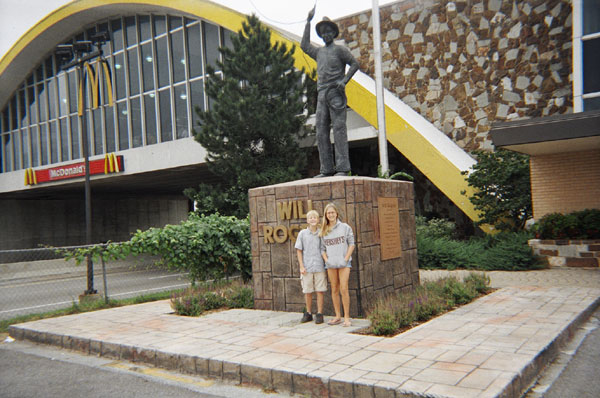 Larissa and Chris stand outside the (at the time) World's Largest McDonald's, stretching over the Oklahoma Turnpike.