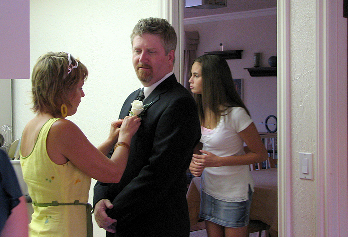 Linnea pins Jim's boutonniere ahead of the ceremony, while Heather looks for Elizabeth.